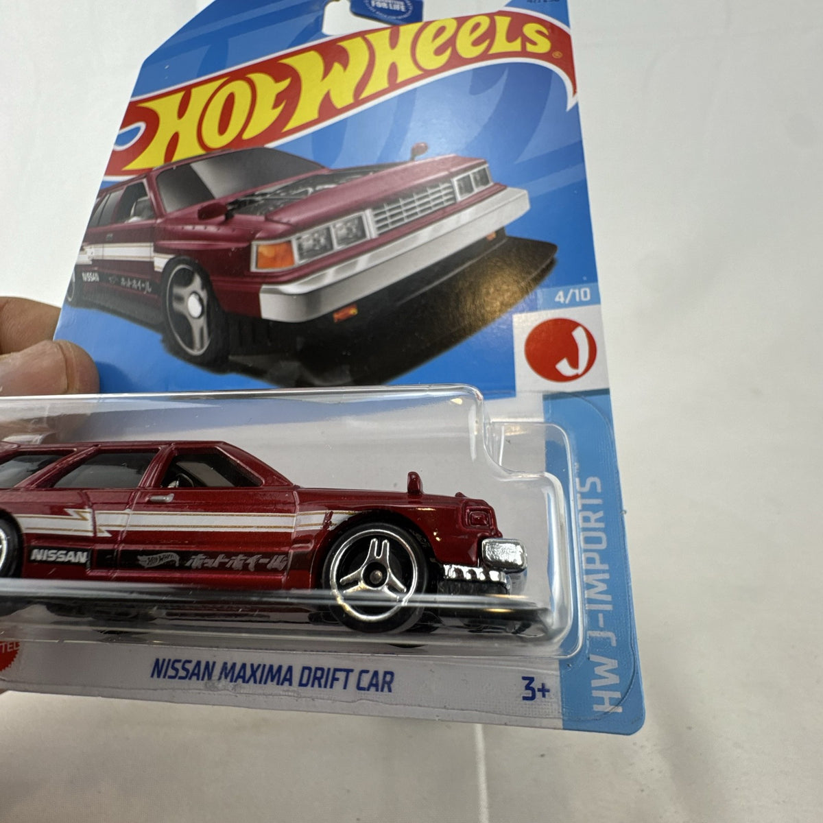 Hot Wheels 1:64 scale Nissan Maxima Drift Car in maroon from the HW J-Imports series factory sealed on card