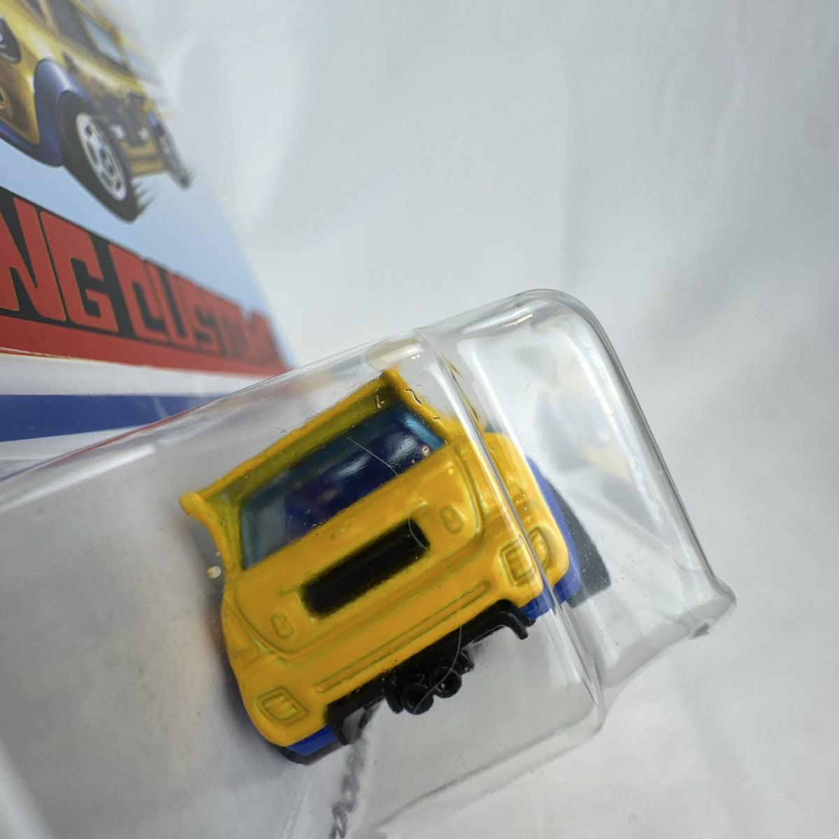 Factory sealed Hot Wheels 1:64 MINI Cooper S Challenge Flying Customs diecast car in yellow with blue racing stripes.