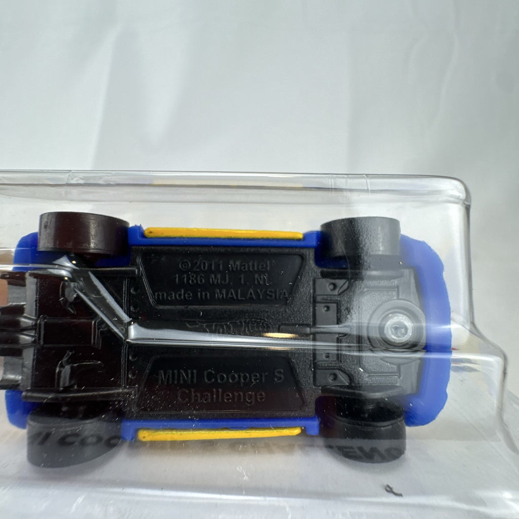 Factory sealed Hot Wheels 1:64 MINI Cooper S Challenge Flying Customs diecast car in yellow with blue racing stripes.