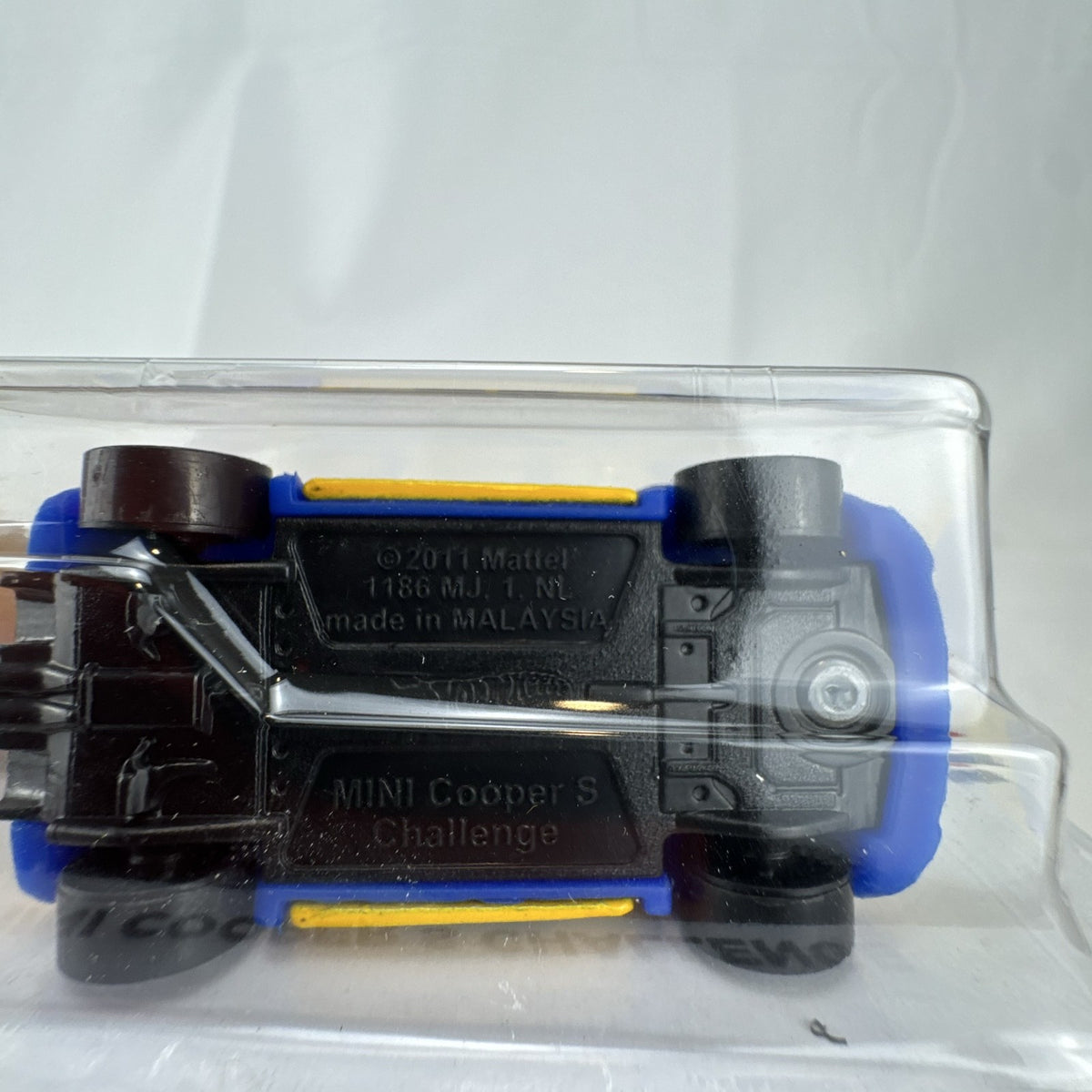 Factory sealed Hot Wheels 1:64 MINI Cooper S Challenge Flying Customs diecast car in yellow with blue racing stripes.