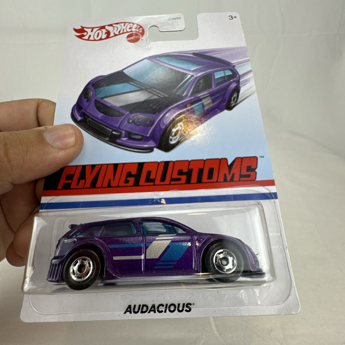 Factory sealed Hot Wheels Flying Customs Audacious 1:64 scale diecast tuner wagon in metallic purple with speed stripes.