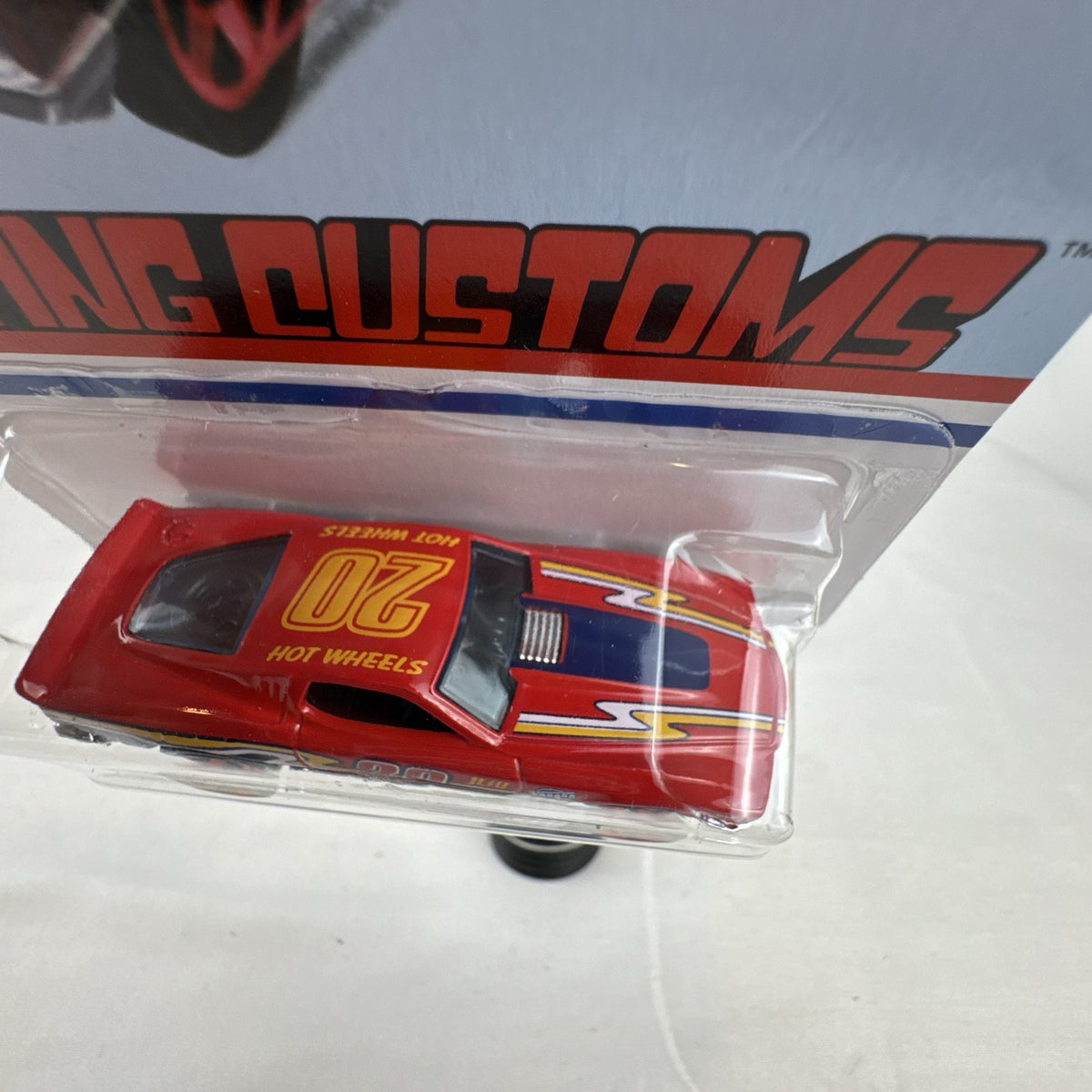Hot Wheels Flying Customs Blvd. Bruiser 1:64 red diecast muscle car in sealed card packaging
