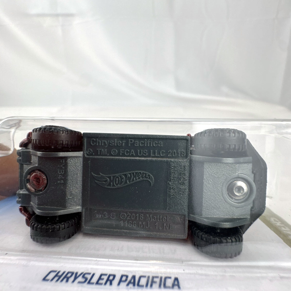 Hot Wheels 1:64 scale red Chrysler Pacifica off-road diecast van in original Baja Blazers blister card packaging.