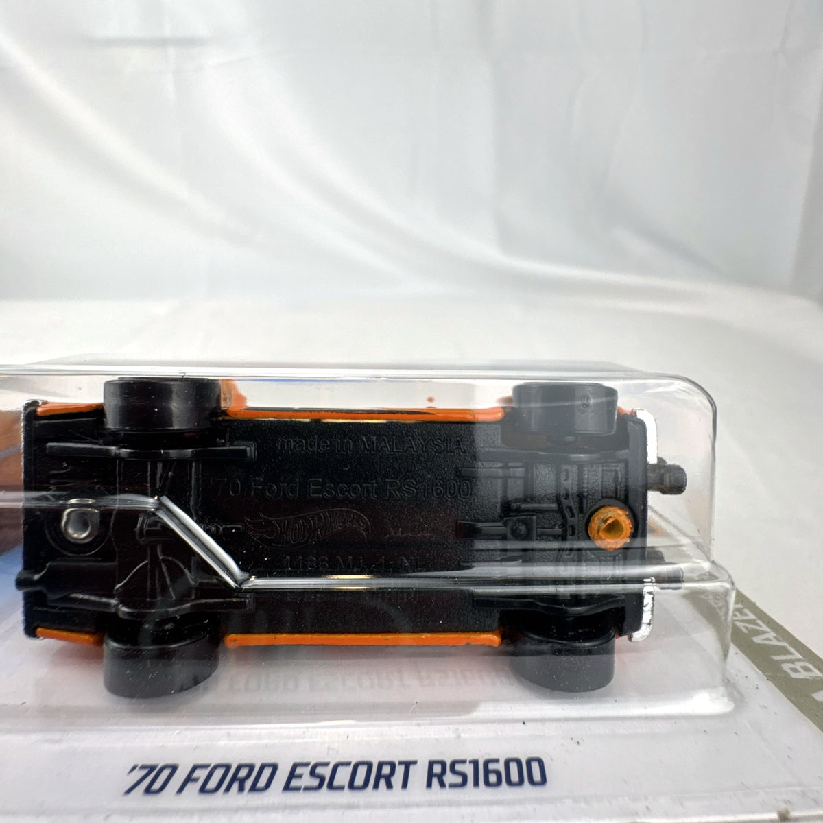 Hot Wheels 1:64 scale 1970 Ford Escort RS1600 diecast rally car in orange sealed on card