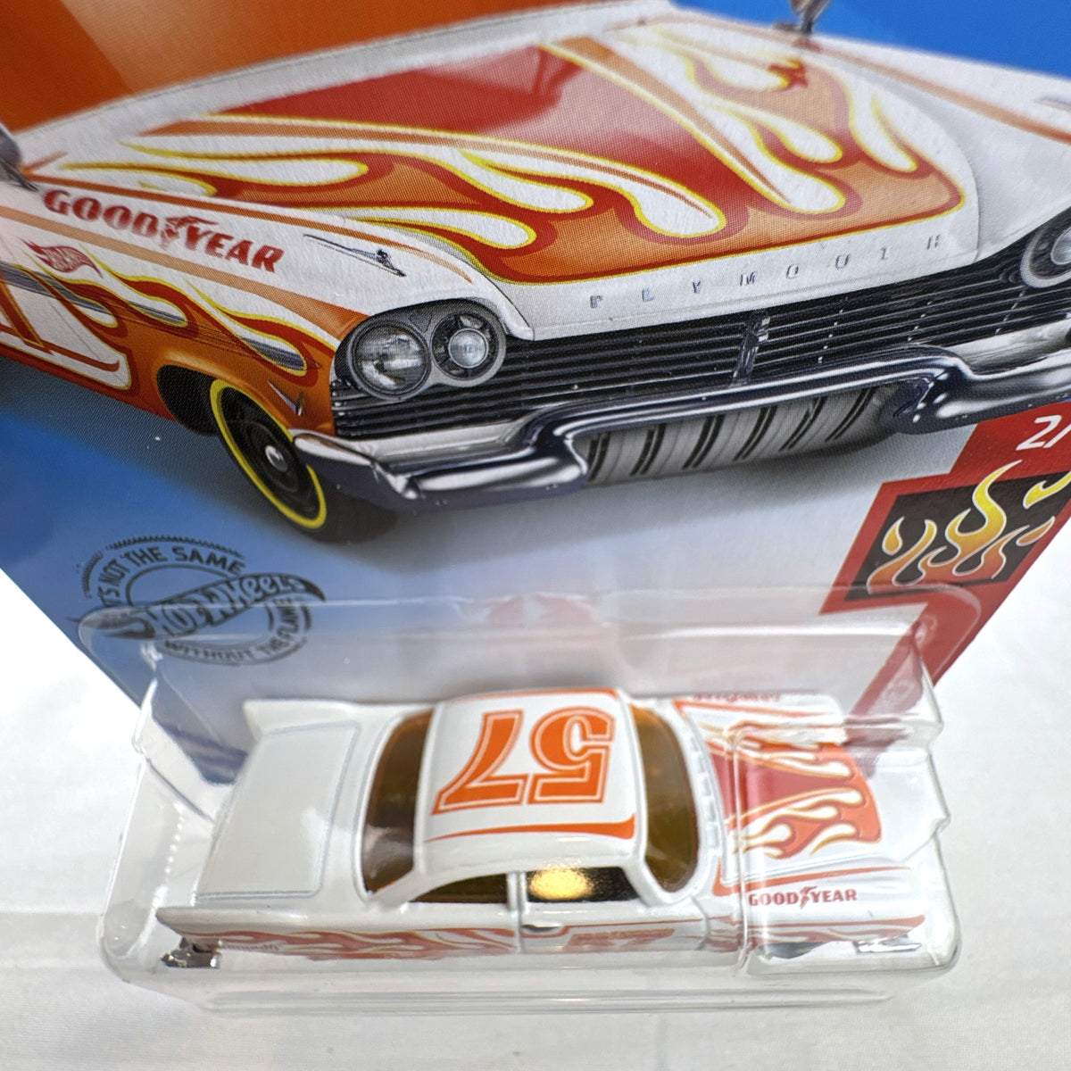 Hot Wheels 1:64 scale '57 Plymouth Fury diecast car in white with HW Flames graphics in original sealed packaging.