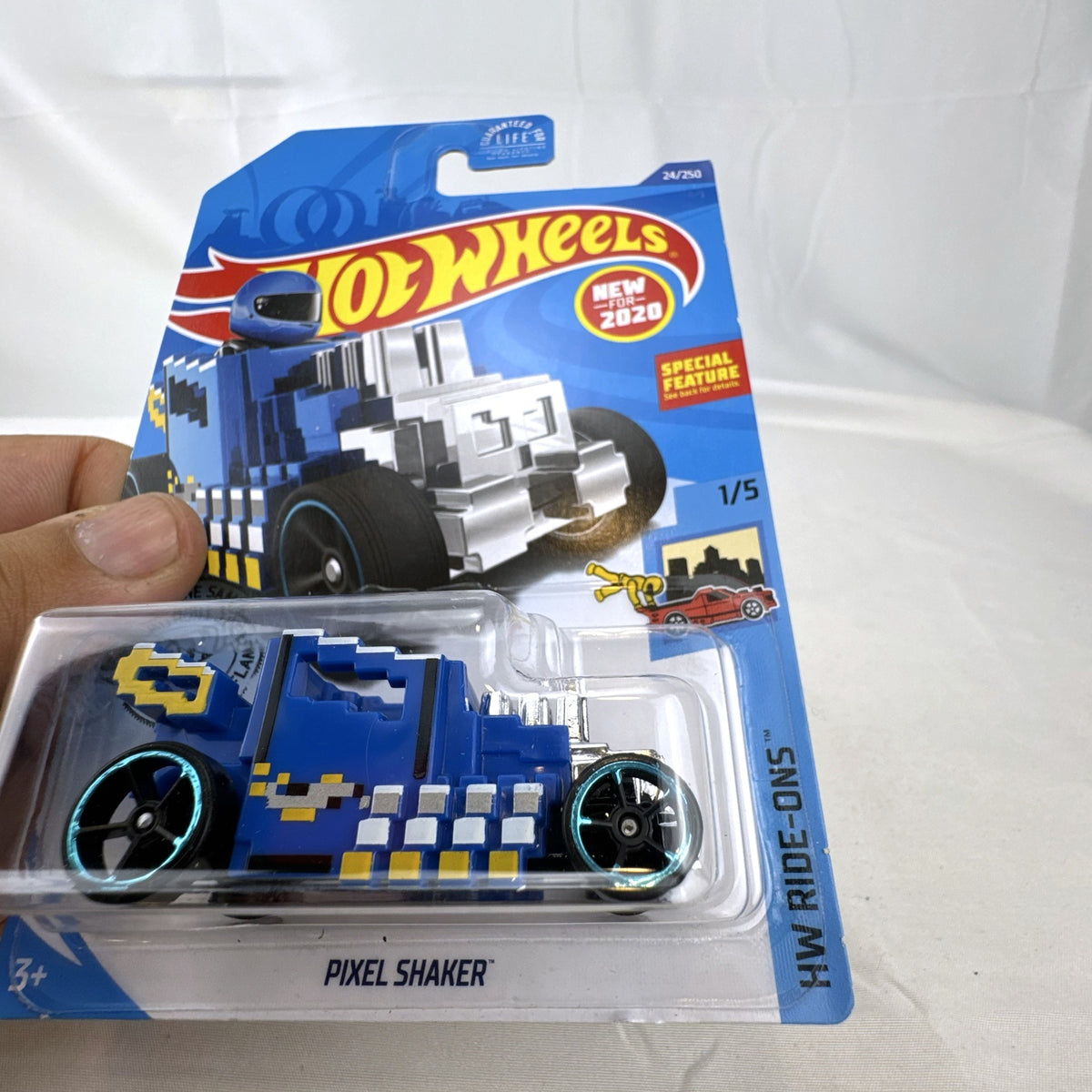 Hot Wheels Pixel Shaker 1:64 scale diecast car in blue with 8-bit graphics, factory sealed on original card.