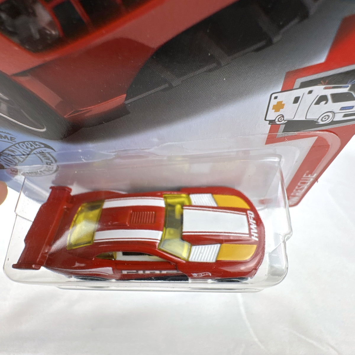 Hot Wheels Custom '11 Chevrolet Camaro HW Rescue diecast car in red, sealed on original backing card.