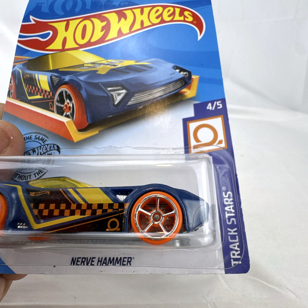Hot Wheels 1:64 scale Nerve Hammer diecast car in deep blue with orange wheels, sealed on original card.