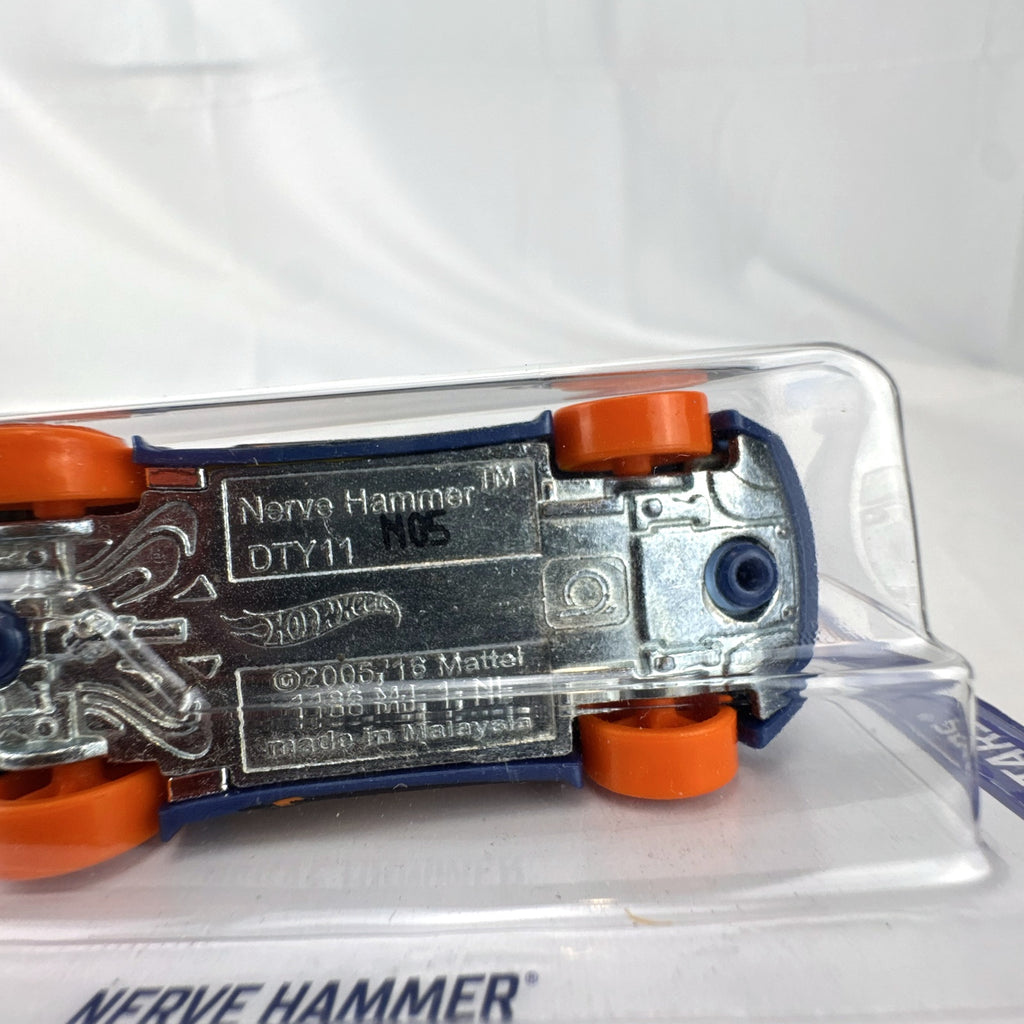 Hot Wheels 1:64 scale Nerve Hammer diecast car in deep blue with orange wheels, sealed on original card.