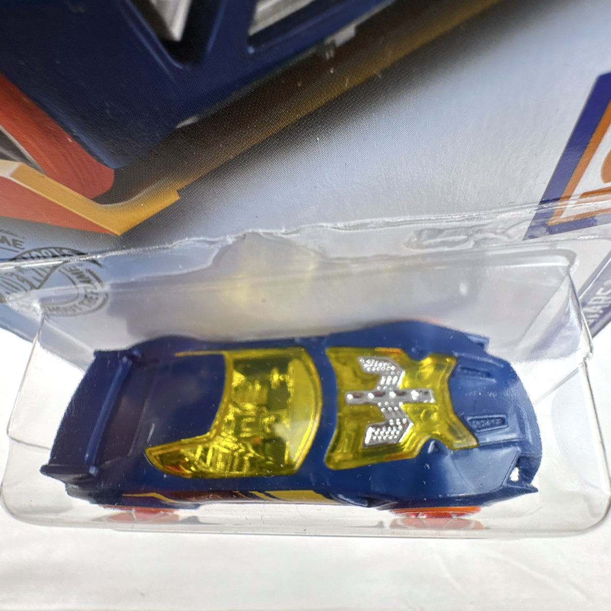 Hot Wheels 1:64 scale Nerve Hammer diecast car in deep blue with orange wheels, sealed on original card.