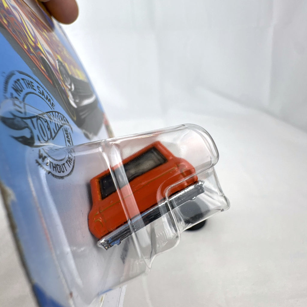 Hot Wheels 1:64 scale 1964 Chevy Nova Wagon diecast car in orange with HW Flames graphics sealed on card.