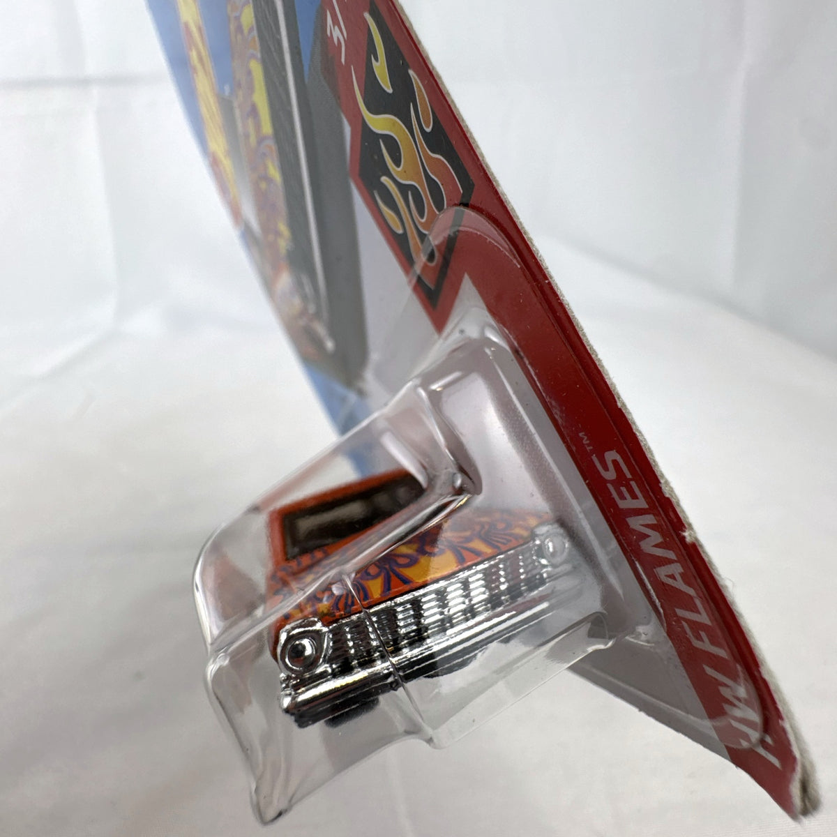 Hot Wheels 1:64 scale 1964 Chevy Nova Wagon diecast car in orange with HW Flames graphics sealed on card.