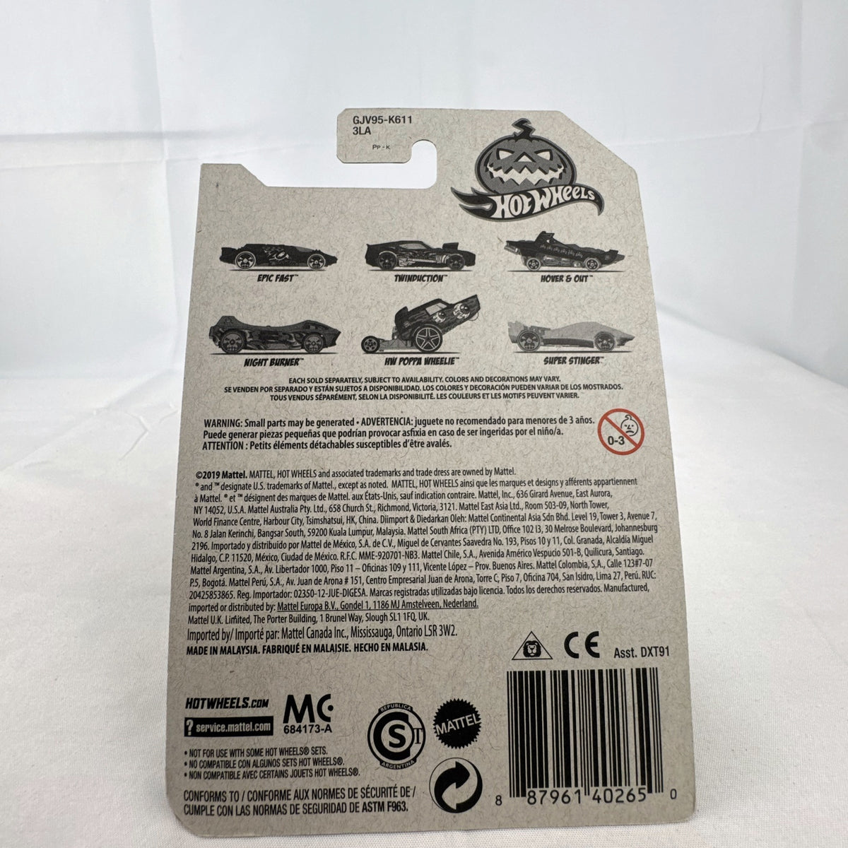 Hot Wheels 1:64 scale Twinduction Halloween Series metallic red diecast muscle car in original sealed packaging.