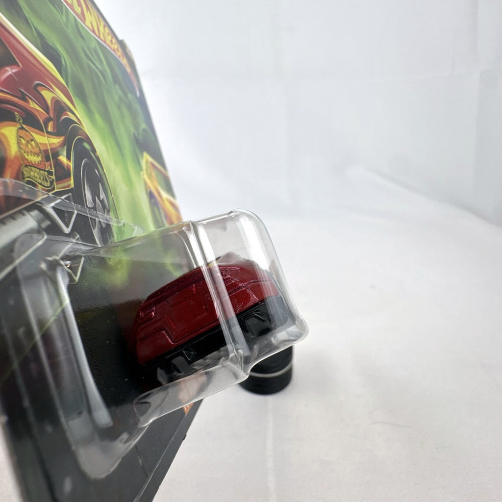 Hot Wheels 1:64 scale Twinduction Halloween Series metallic red diecast muscle car in original sealed packaging.