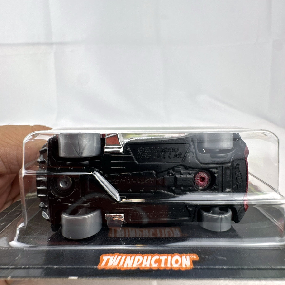 Hot Wheels 1:64 scale Twinduction Halloween Series metallic red diecast muscle car in original sealed packaging.