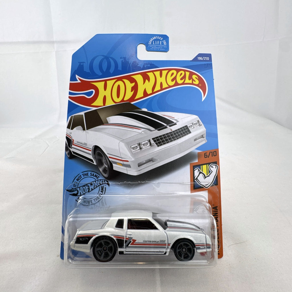 Hot Wheels 1:64 scale 1986 Chevrolet Monte Carlo SS diecast car in white with retro stripes in factory sealed packaging