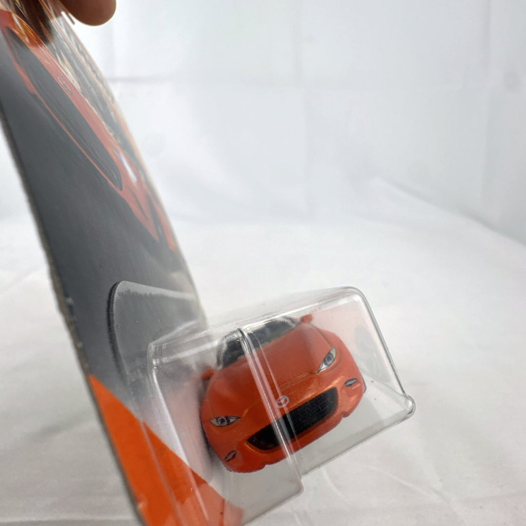 Factory-sealed Matchbox 1:64 scale 2015 Mazda MX-5 Miata diecast model car in metallic orange on original blister card