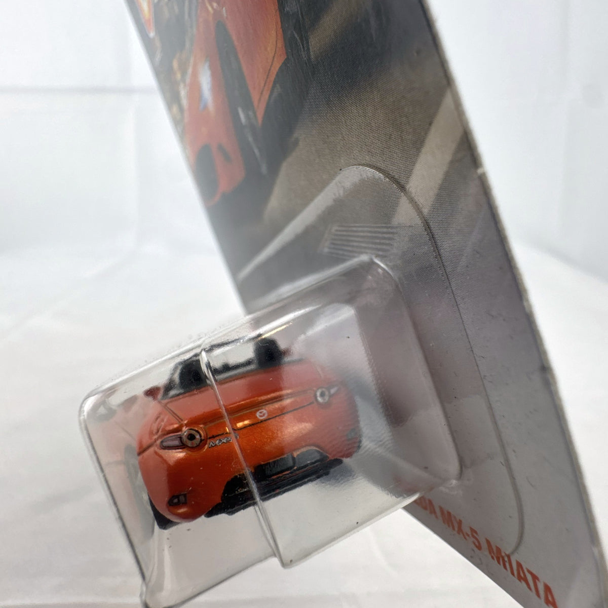 Factory-sealed Matchbox 1:64 scale 2015 Mazda MX-5 Miata diecast model car in metallic orange on original blister card