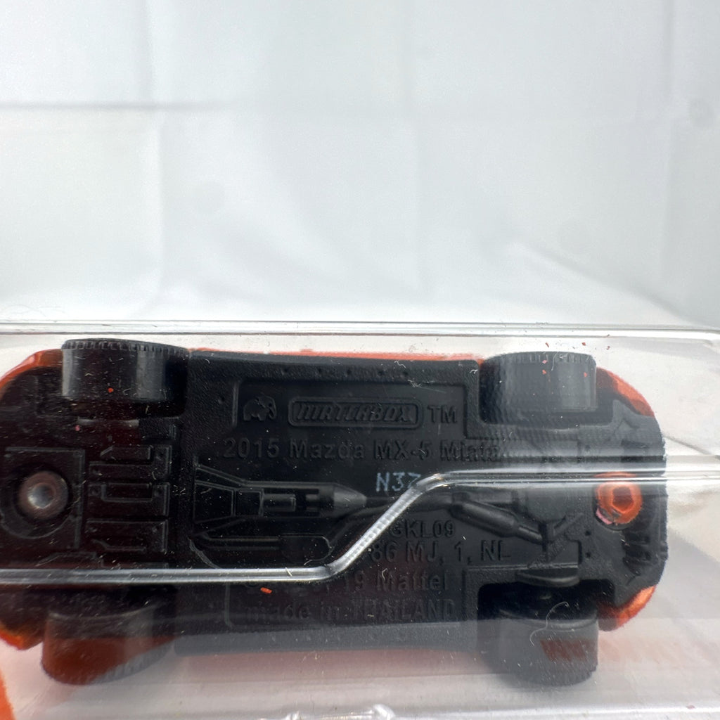 Factory-sealed Matchbox 1:64 scale 2015 Mazda MX-5 Miata diecast model car in metallic orange on original blister card