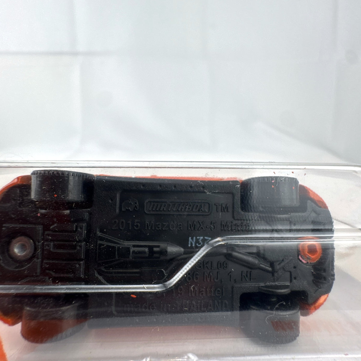 Factory-sealed Matchbox 1:64 scale 2015 Mazda MX-5 Miata diecast model car in metallic orange on original blister card