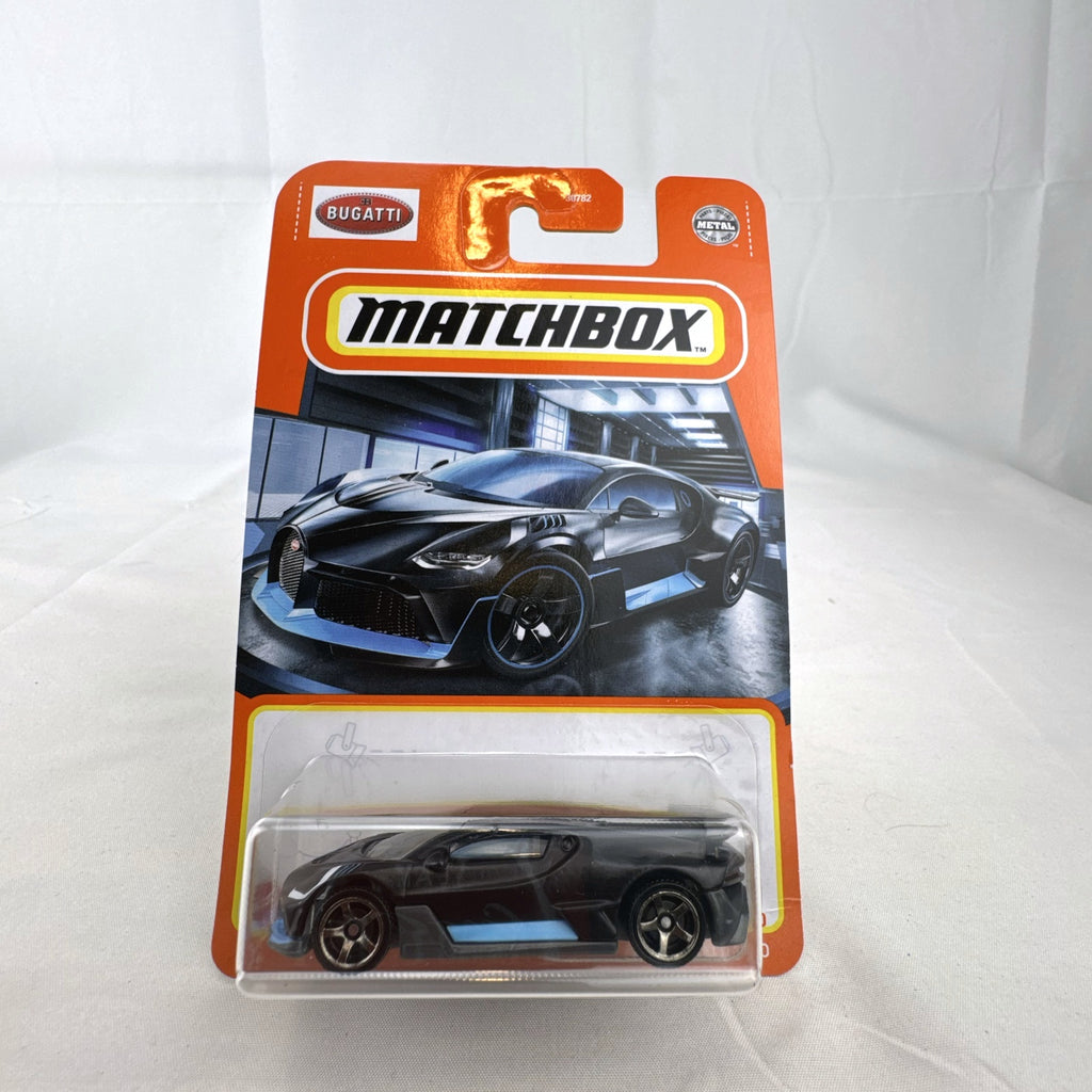 Matchbox 1:64 scale Bugatti Divo diecast car in matte black with blue accents on original card packaging