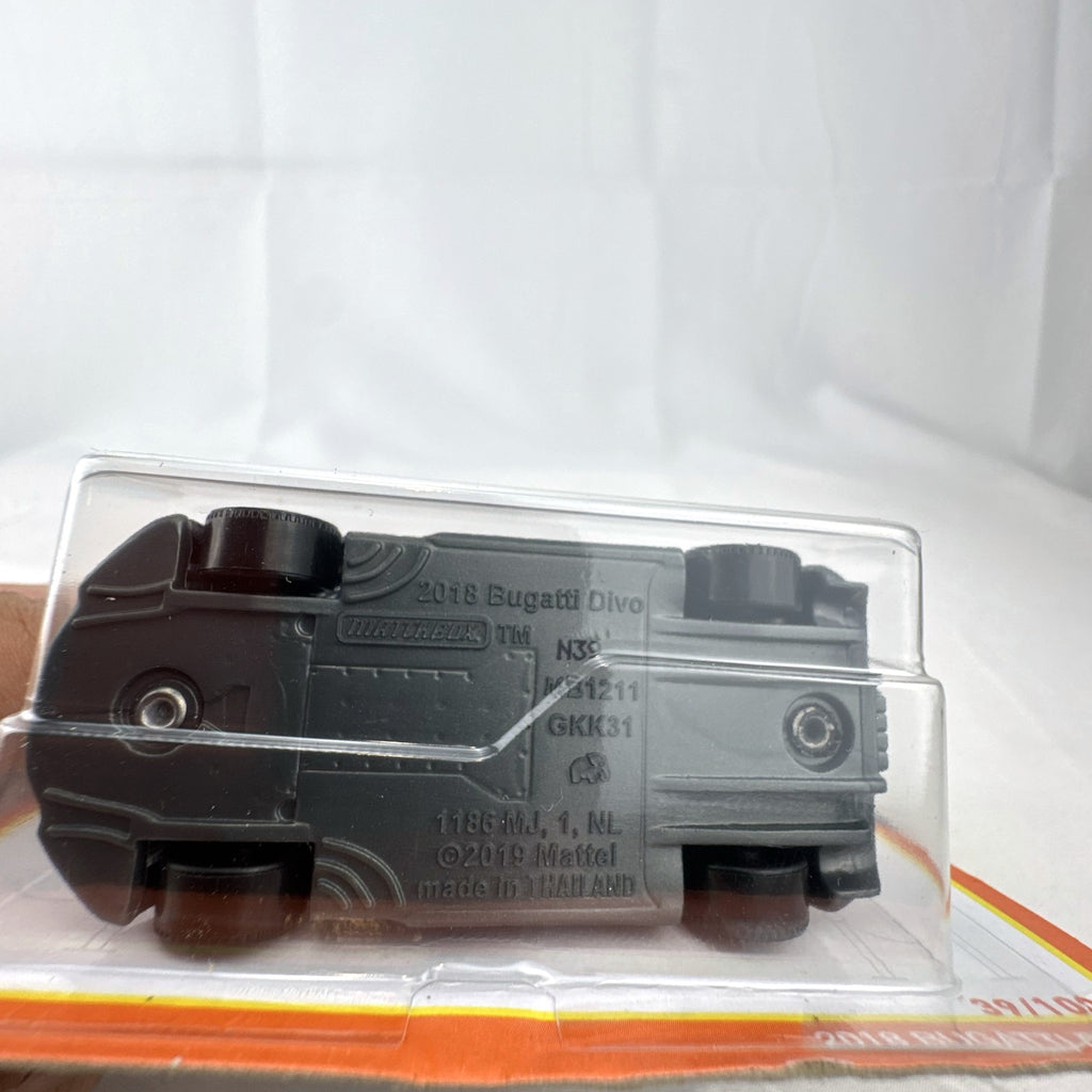 Matchbox 1:64 scale Bugatti Divo diecast car in matte black with blue accents on original card packaging