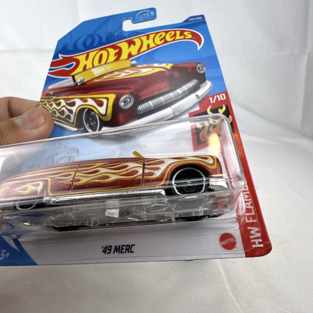 Hot Wheels 1:64 scale '49 Merc diecast convertible in metallic red with yellow and white flame graphics, sealed on card.