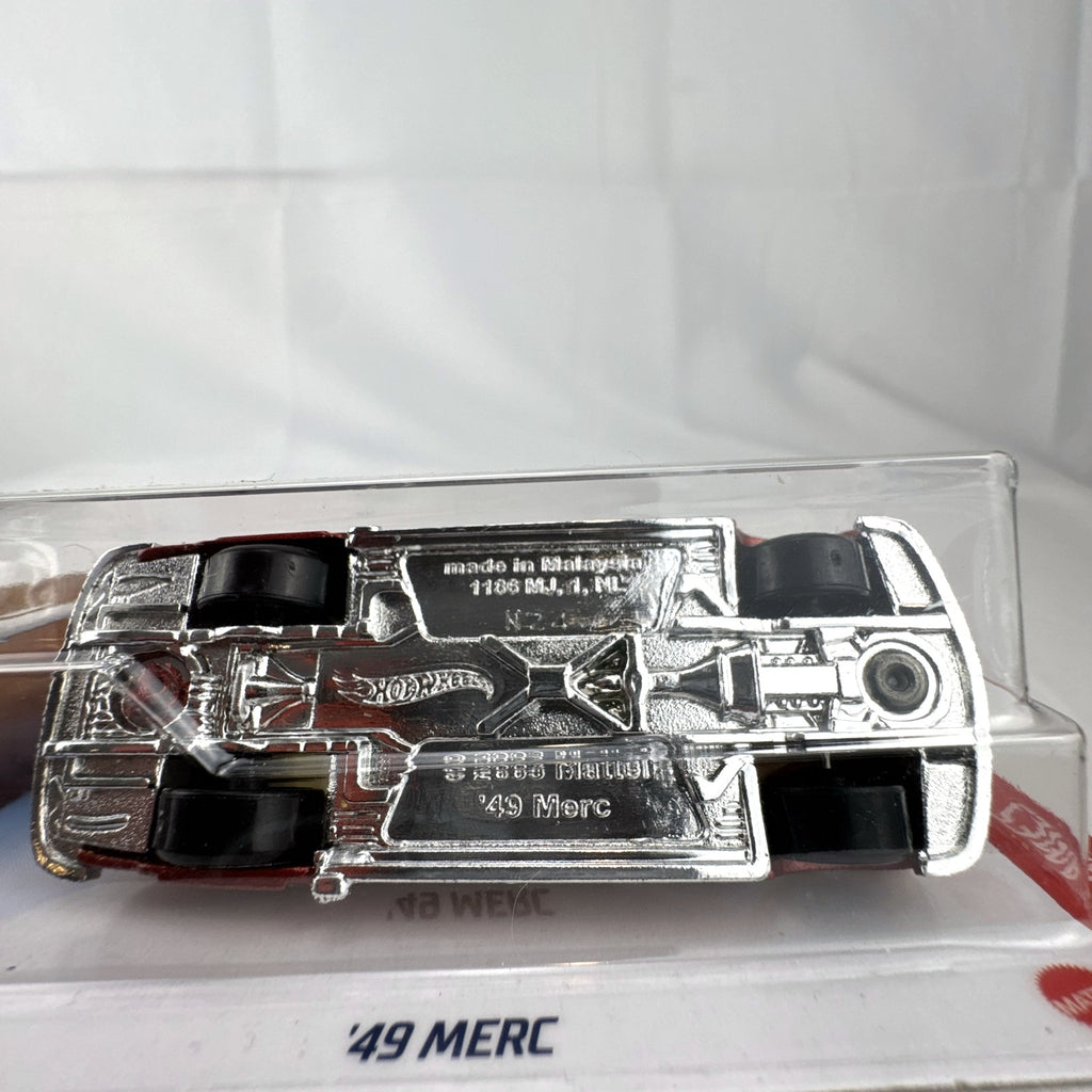 Hot Wheels 1:64 scale '49 Merc diecast convertible in metallic red with yellow and white flame graphics, sealed on card.