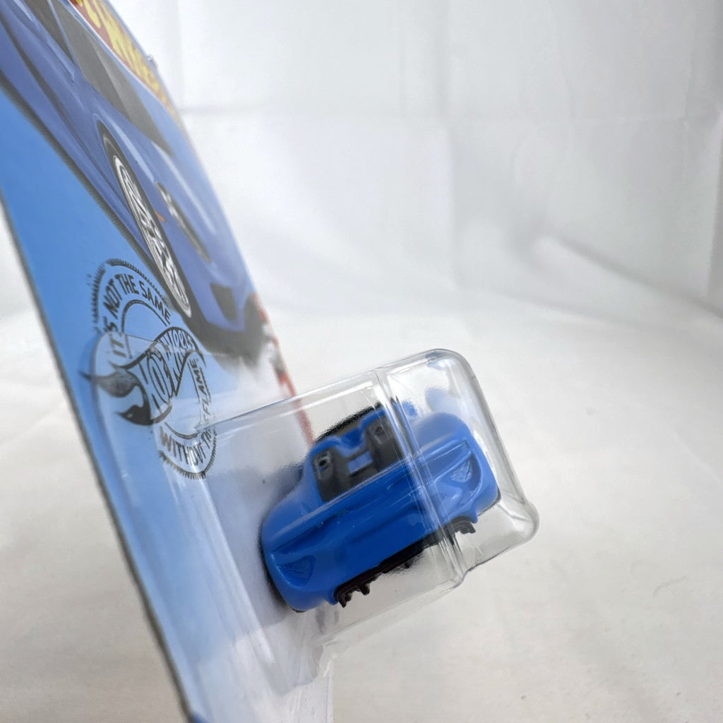 Sealed 1:64 scale Hot Wheels Porsche 918 Spyder diecast car in blue with white racing stripes in original packaging
