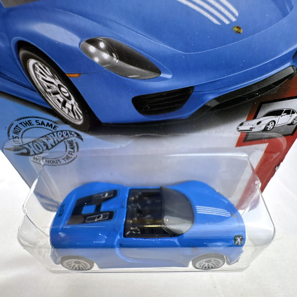 Sealed 1:64 scale Hot Wheels Porsche 918 Spyder diecast car in blue with white racing stripes in original packaging