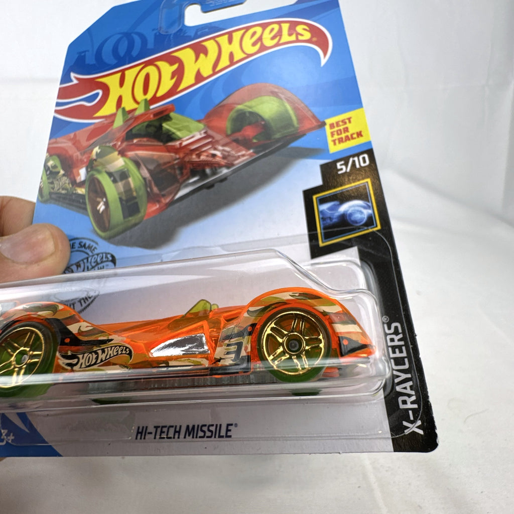 Hot Wheels 1:64 scale Hi-Tech Missile diecast car in translucent orange X-Raycers packaging.