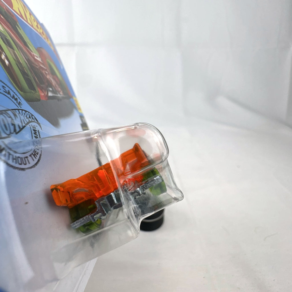 Hot Wheels 1:64 scale Hi-Tech Missile diecast car in translucent orange X-Raycers packaging.