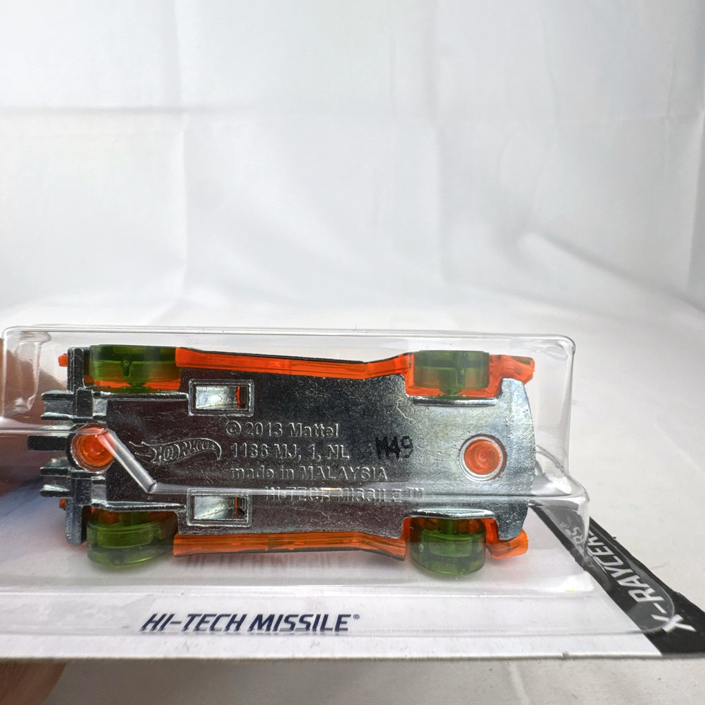Hot Wheels 1:64 scale Hi-Tech Missile diecast car in translucent orange X-Raycers packaging.