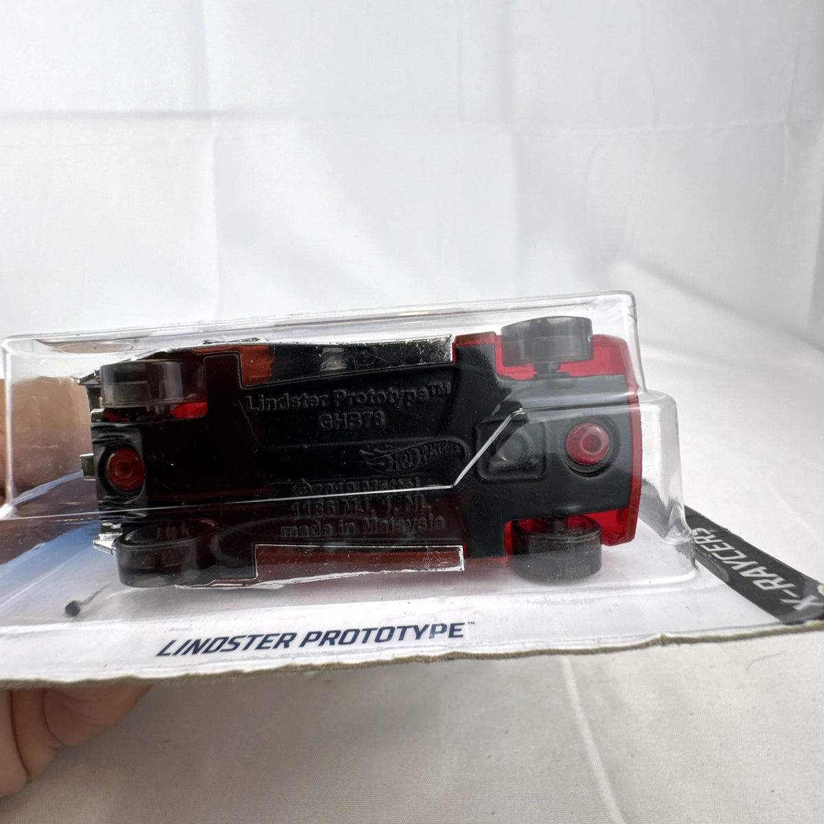 Hot Wheels Lindster Prototype 1:64 scale diecast car in translucent red sealed on original X-Raycers cardback