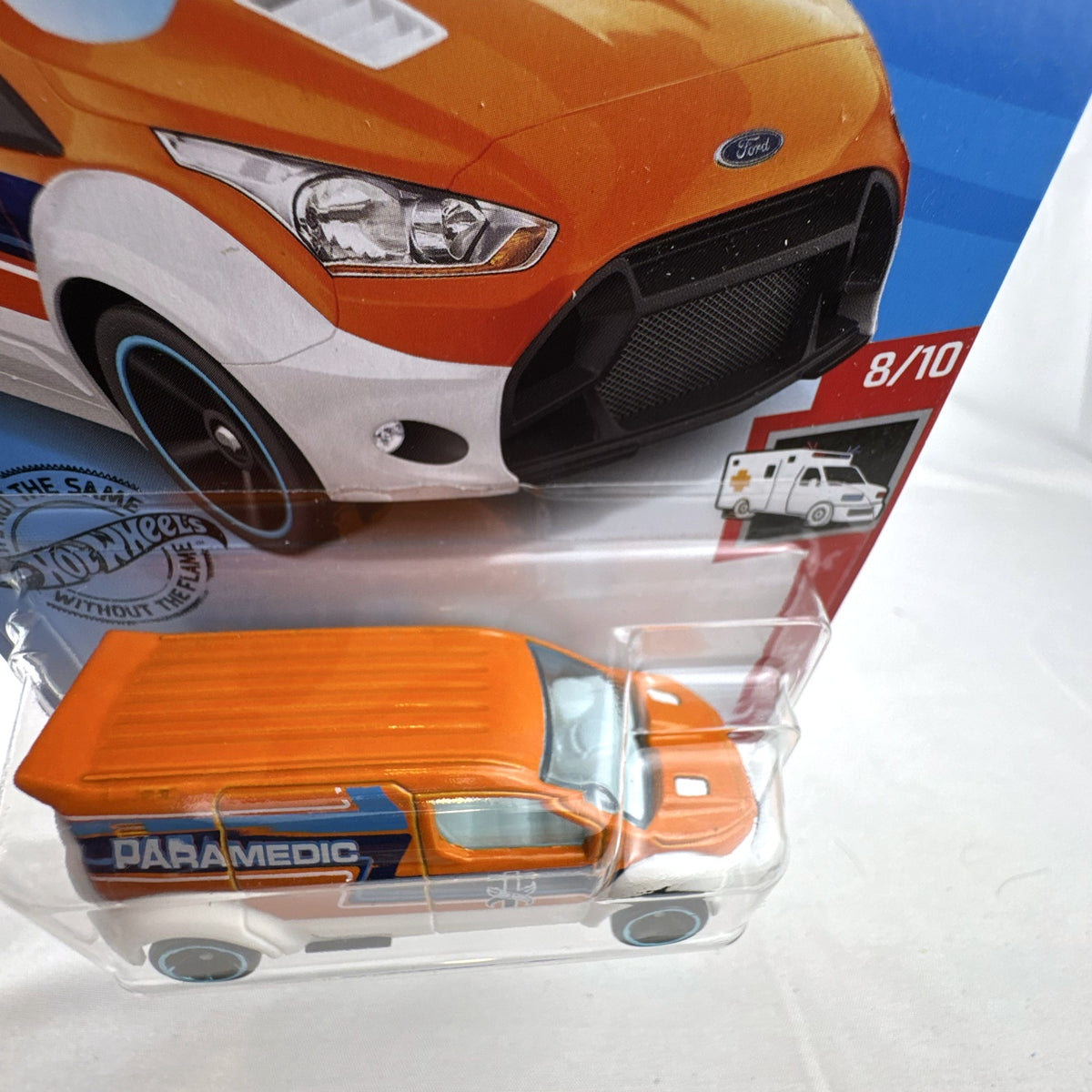Hot Wheels 1:64 Ford Transit Connect Paramedic Van in orange and blue from the HW Rescue series sealed on card.
