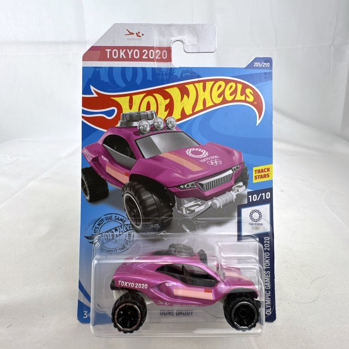 Hot Wheels Dune Daddy 1:64 diecast car in metallic pink with Tokyo 2020 Olympic Games Beach Volleyball graphics