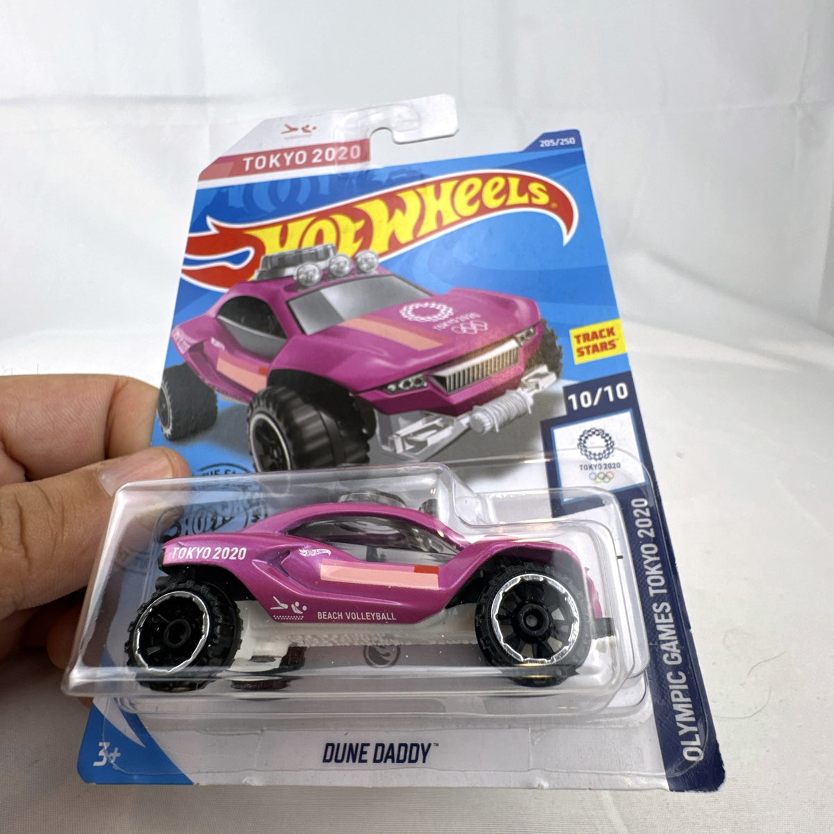 Hot Wheels Dune Daddy 1:64 diecast car in metallic pink with Tokyo 2020 Olympic Games Beach Volleyball graphics