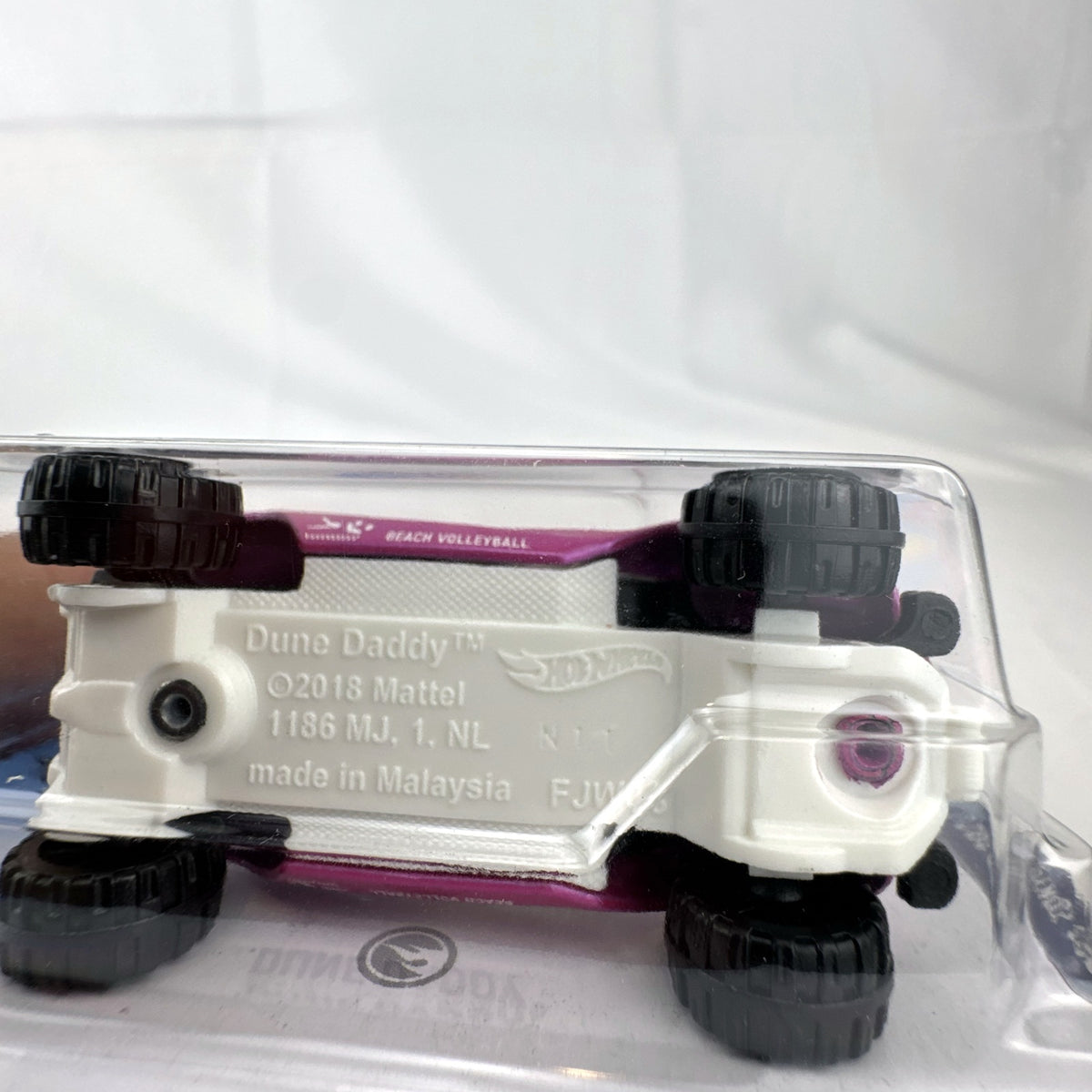 Hot Wheels Dune Daddy 1:64 diecast car in metallic pink with Tokyo 2020 Olympic Games Beach Volleyball graphics