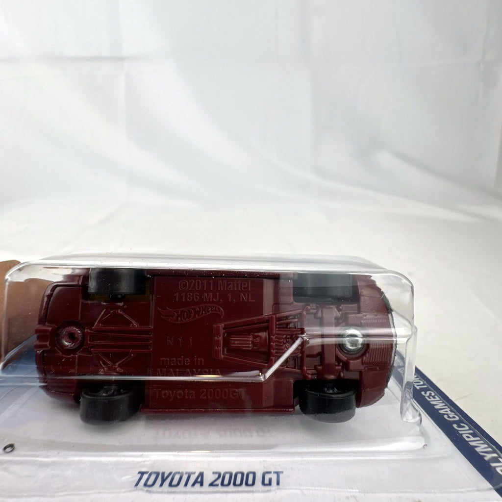 Sealed Hot Wheels 1:64 Toyota 2000 GT Tokyo 2020 Olympic Games Karate edition in deep maroon on original card.