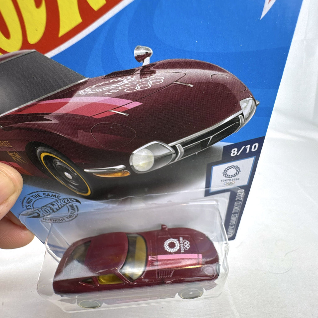 Sealed Hot Wheels 1:64 Toyota 2000 GT Tokyo 2020 Olympic Games Karate edition in deep maroon on original card.