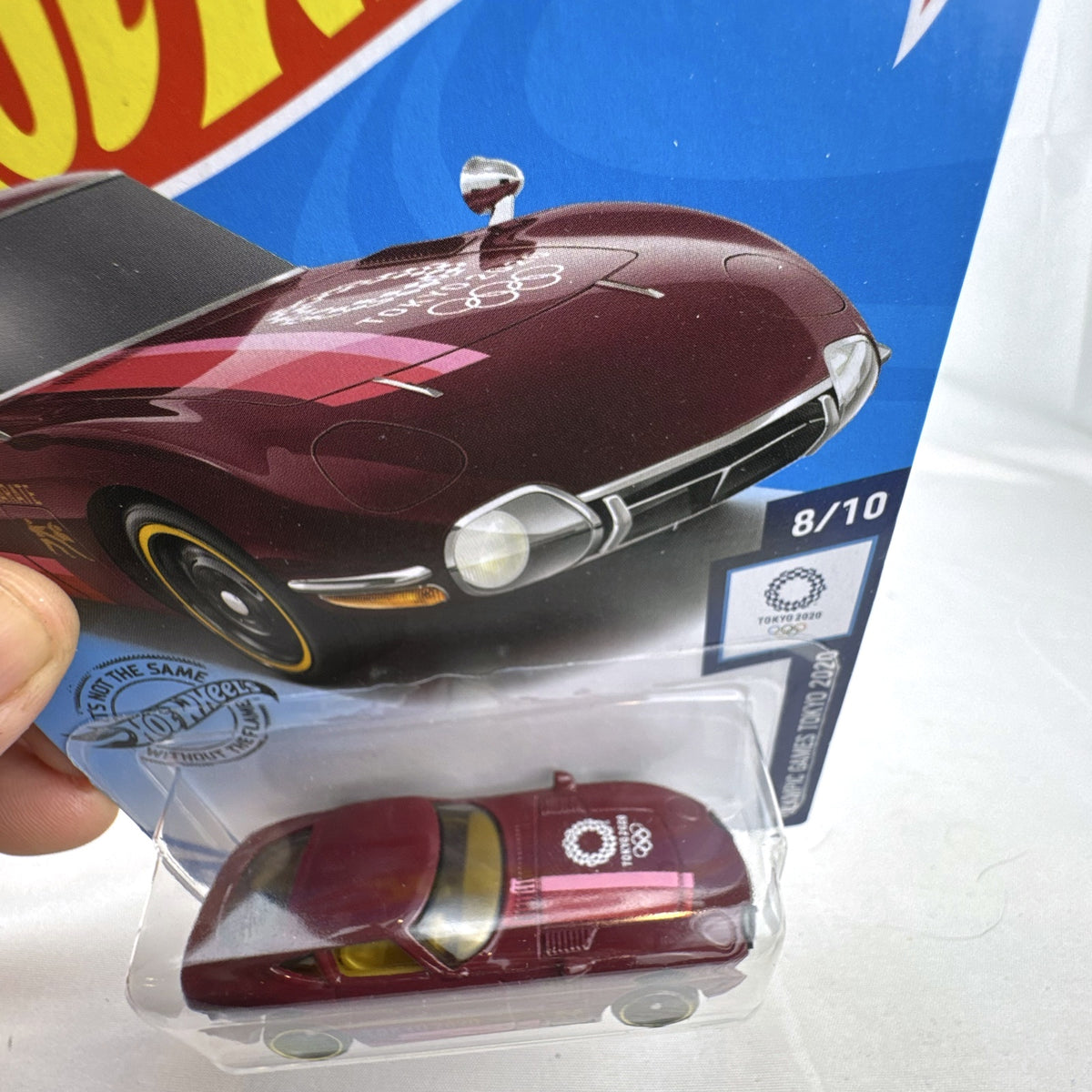 Sealed Hot Wheels 1:64 Toyota 2000 GT Tokyo 2020 Olympic Games Karate edition in deep maroon on original card.