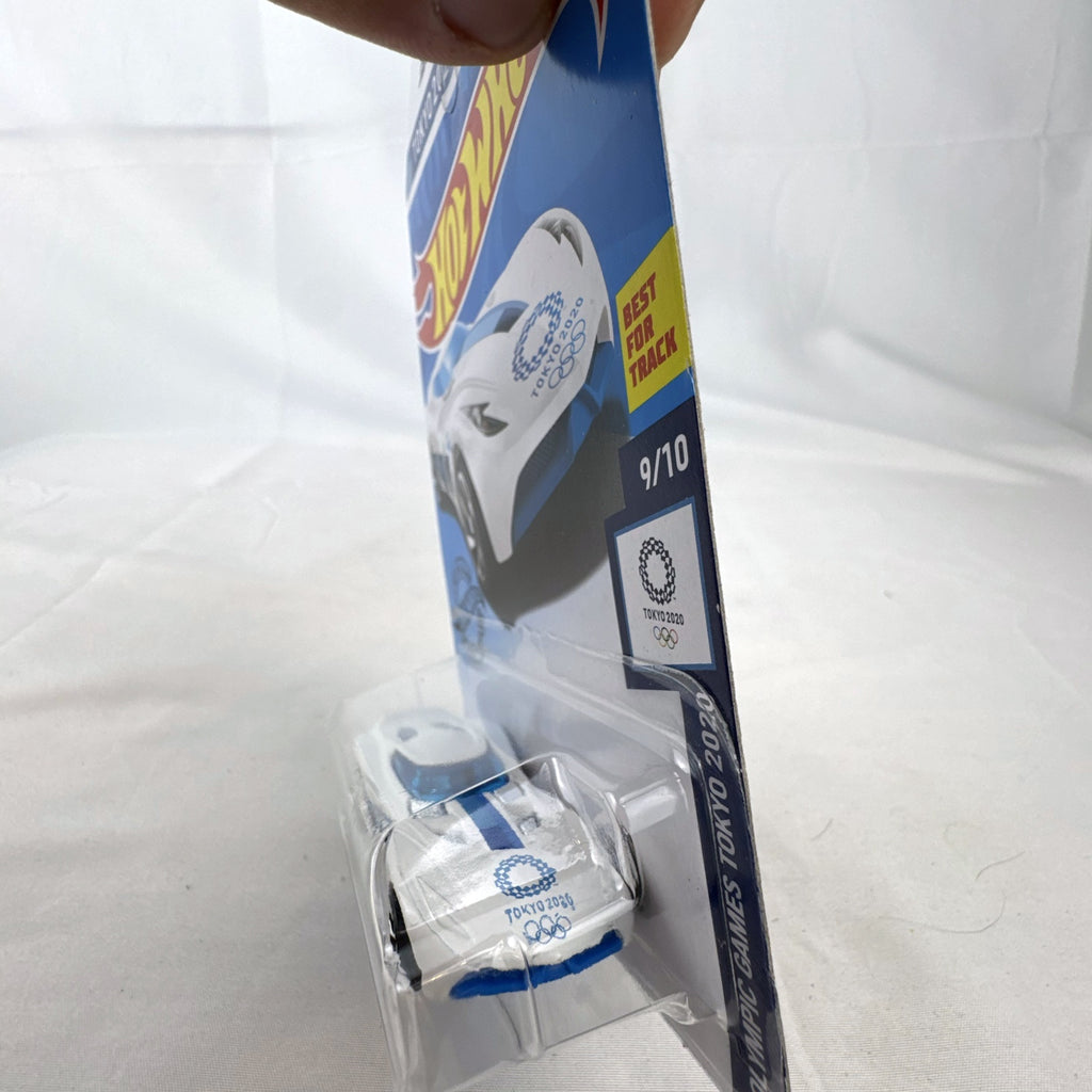 Hot Wheels 1:64 scale Velocita diecast car in white with Tokyo 2020 Olympic Swimming graphics, factory sealed.