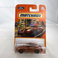 Matchbox 1:64 scale Ford Police Interceptor Fire Chief diecast car in original red packaging with gold push bumper.