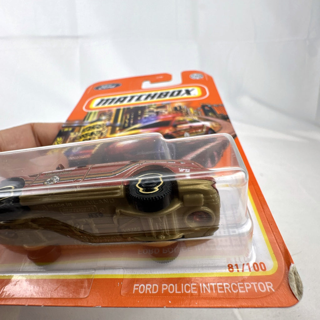 Matchbox 1:64 scale Ford Police Interceptor Fire Chief diecast car in original red packaging with gold push bumper.
