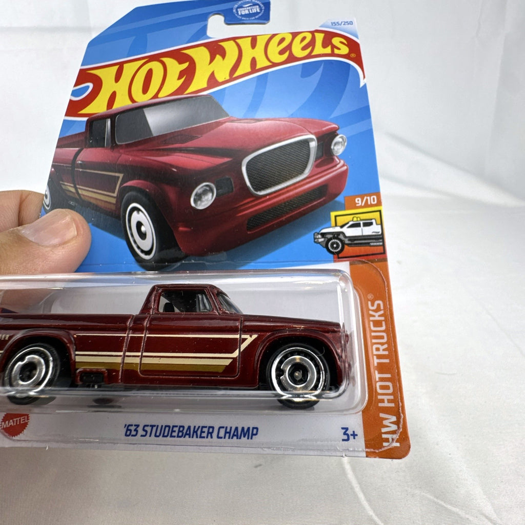 Hot Wheels 1:64 1963 Studebaker Champ diecast pickup truck in dark red metallic on original sealed card