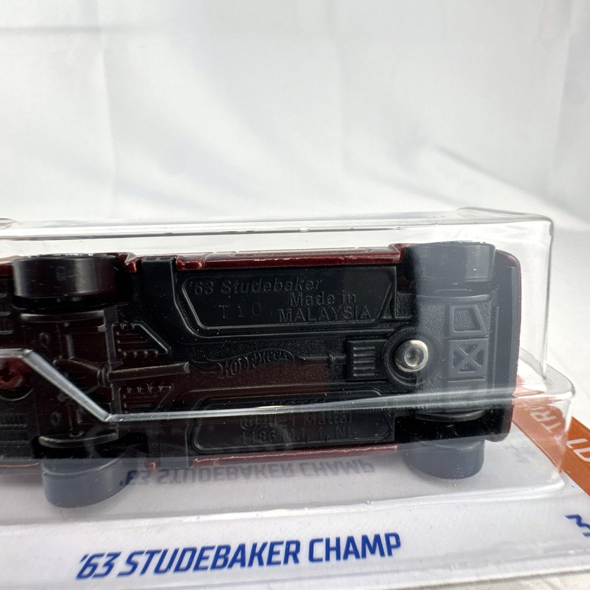 Hot Wheels 1:64 1963 Studebaker Champ diecast pickup truck in dark red metallic on original sealed card