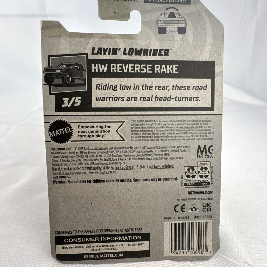 Hot Wheels 1:64 scale Layin' Lowrider diecast car in gold with red and white flame tampos in original carded packaging
