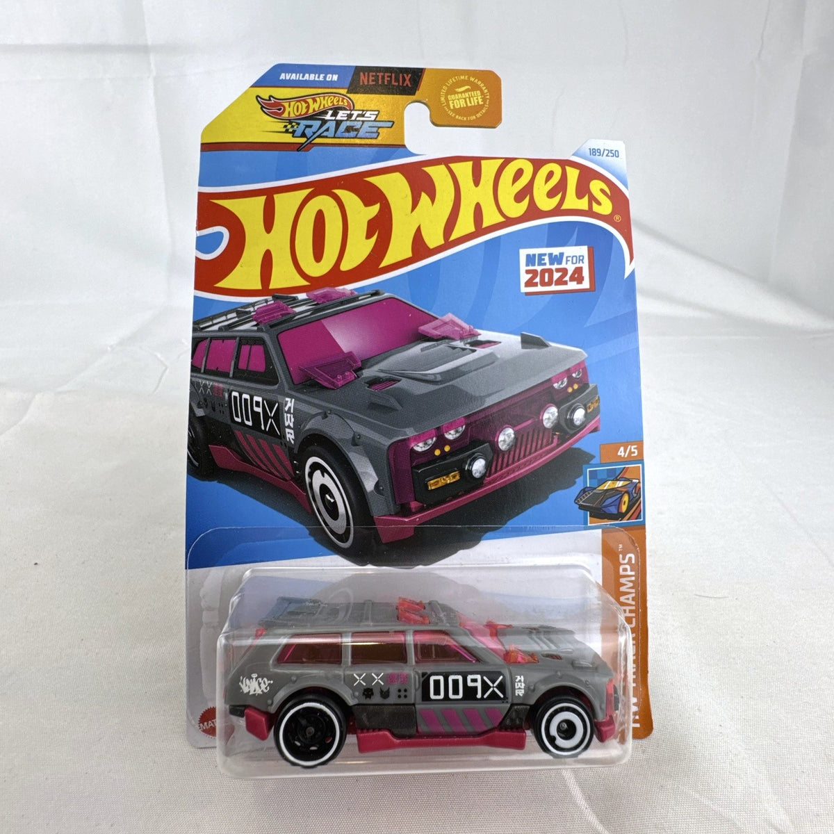 Hot Wheels Track Dwagon 1:64 scale diecast car in dark grey with pink graphics, factory sealed on card.