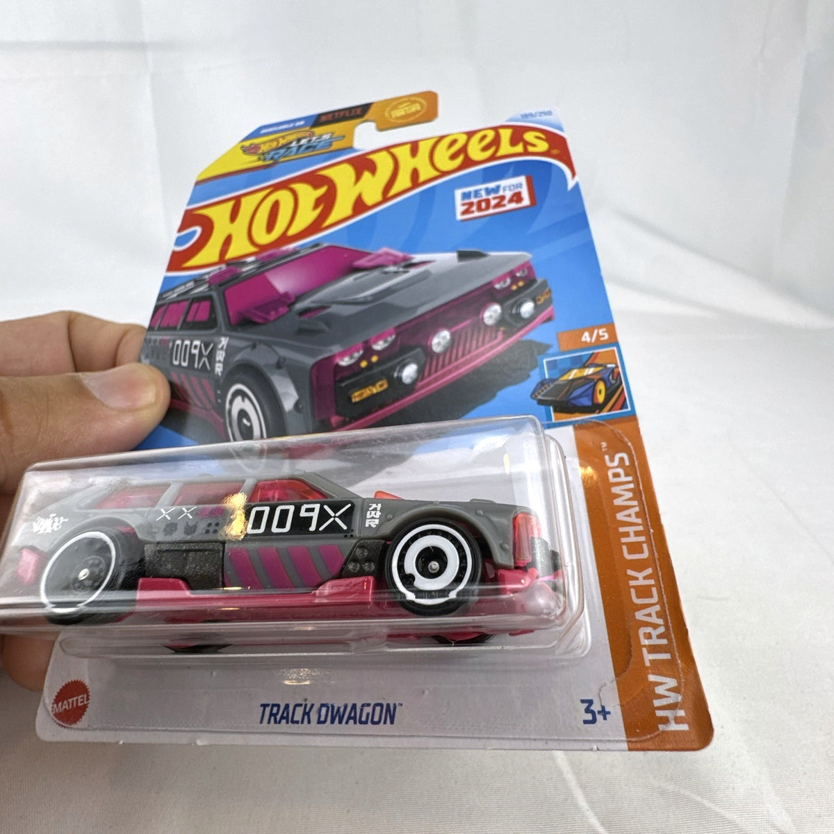 Hot Wheels Track Dwagon 1:64 scale diecast car in dark grey with pink graphics, factory sealed on card.