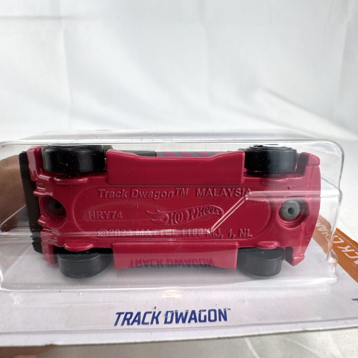 Hot Wheels Track Dwagon 1:64 scale diecast car in dark grey with pink graphics, factory sealed on card.